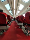 Interior of empty train car with rows of red seats Royalty Free Stock Photo