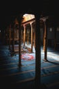 The interior of Esrefoglu Mosque in Konya Beysehir with its wooden columns and carpets Royalty Free Stock Photo