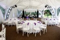 Interior of a event tent decoration ready for guests. Served round banquet table outdoor in marquee Royalty Free Stock Photo