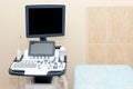 Interior of examination room with ultrasonography machine in hospital laboratory. Modern medical equipment background.