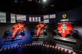 Interior exhibit showcasing an array of Ferrari racecars at a museum.