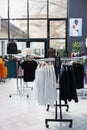 Interior of fashionable boutique with clothes on hangers