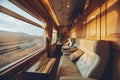 Interior of first class train coach with tables and comfortable couches and railway in the window. Luxury traveling