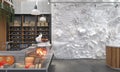 The interior of the food store or supermarket with white monochrome composition of relief figures of foods and drinks on the wall