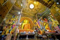 Interior of Gangaramaya Temple with iconic large seated Buddha image in `earth touching` pose, Colombo, Sri Lanka