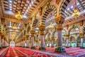Sunlight Streaming into a Large Mosque Interior with Green Arches and Golden Details islamic Royalty Free Stock Photo