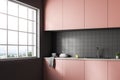 Interior of gray tile kitchen, pink countertops