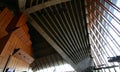 Wood wall, large glass glazing window, tall concrete wedged ceiling with exposed beams in foyer of Sydney Opera House, Australia