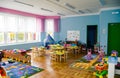 The interior of a group in a kindergarten with a lot of toys, educational games and bright furniture