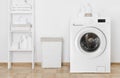 Interior of home laundry room with washing machine near wall Royalty Free Stock Photo