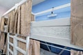 Interior of the hostel room. Bunk beds with fabric blinds Royalty Free Stock Photo