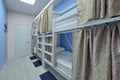 Interior of the hostel room. Bunk beds with fabric blinds Royalty Free Stock Photo
