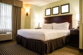 Hotel bedroom with white bed Royalty Free Stock Photo