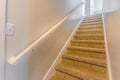 Interior of a house with a staircase covered with brown carpet Royalty Free Stock Photo