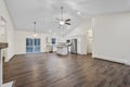 Interior of a house with white walls, a parquet floor, hanging lamps, and a patio sliding door Royalty Free Stock Photo