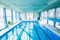 An interior of an indoor public swimming pool. Royalty Free Stock Photo