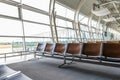 Interior inside airport terminal. Lounge with chairs in waiting departure area. Summer vacation. Airplane travel concept