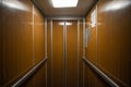 Interior inside a closed clean old Soviet elevator car lined with wood