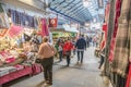 Interior inside of market hall showing a variety of stalls vendors and customers browsing