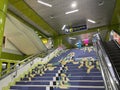 Interior inside train station featuring stairs towards departure train.