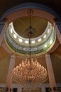 Interior of an Islamic museum with Arabic letters on the ceiling over a luxurious chandelier