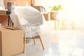 Interior items and packed carton boxes in room. Moving house concept