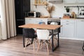 Interior of kitchen in rustic style with vintage kitchen ware and wooden wall. White furniture and wooden decor in