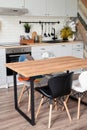 Interior of kitchen in rustic style with vintage kitchen ware and wooden wall. White furniture and wooden decor in