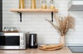 Interior of kitchen in rustic style with vintage kitchen ware and wooden wall. White furniture and wooden decor in