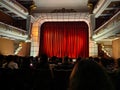 Interior of the Kutaisi State Opera Theater big stage with red curtains before the play begins