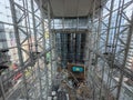 Interior of Langham Place with steel structures and a long escalator with people walking on the lower floor, surrounded Royalty Free Stock Photo