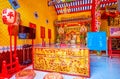 Interior of Lao Pun Tao Kong shrine with amazing table with carved golden dragons in chineese style, Bangkok, Thailand