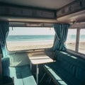 Interior of a large caravan auto trailer, outside the window sees a beautiful natural landscape sea and beach