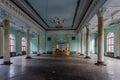 Interior of large column hall with fretwork at abandoned mansion