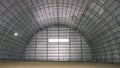Empty arched warehouse with metal walls and ground Royalty Free Stock Photo