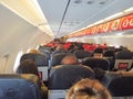 Interior of large passenger airplane with people, on seat and waiting for take off