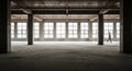 Lone Worker in Unfinished Concrete Building with Large Windows and Red Pipes construction interior Royalty Free Stock Photo