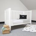 Interior of light baby room with a cozy crib and woven wicker boxes for clothes or accessories Royalty Free Stock Photo