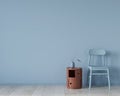 Interior in light blue with a chair and terracotta bedside table