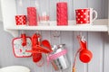 Shelves with dishes. Interior light grey kitchen and red christmas decor. Preparing lunch at home on the kitchen concept Royalty Free Stock Photo