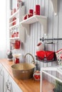 Shelves with dishes. Interior light grey kitchen and red christmas decor. Preparing lunch at home on the kitchen concept Royalty Free Stock Photo