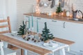 Interior light kitchen with christmas decor and tree Royalty Free Stock Photo