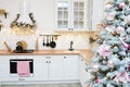 Interior light kitchen with pink christmas decor and lights Royalty Free Stock Photo