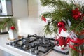 Interior light kitchen and red christmas decor. Focus on tree Royalty Free Stock Photo