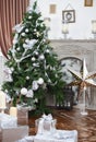 Daily interior in light tones decked out with Christmas tree Royalty Free Stock Photo