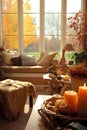 Interior of living room with autumn decor, candles, pumpkins and autumn leaves