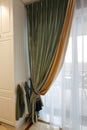 The interior of the living room, beautiful curtains and drapes on the window. Royalty Free Stock Photo