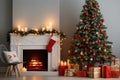 Interior of living room with fireplace, presents and Christmas tree Royalty Free Stock Photo