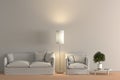 Interior of living room with white fabric sofa and armchair, floor lamp and lemon tree in vase on wooden coffee table