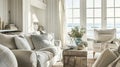 Interior of a living room with white walls, sofa and cushions. Sitting room in coastal cottage with sea view Royalty Free Stock Photo